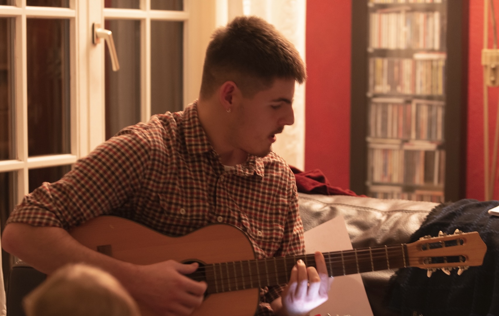 a picture of Reuben playing a small-ish guitar